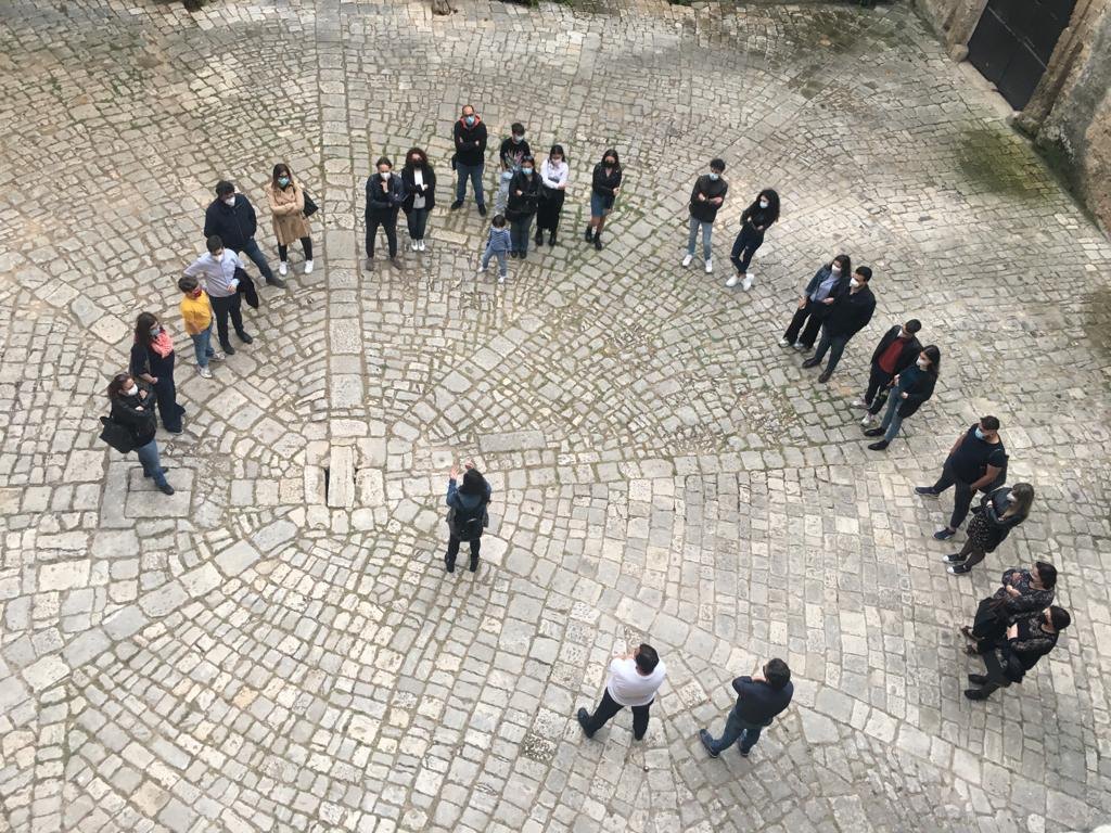 A guided visit in a stone courtyard of the old town, Manduria, Salento, Puglia